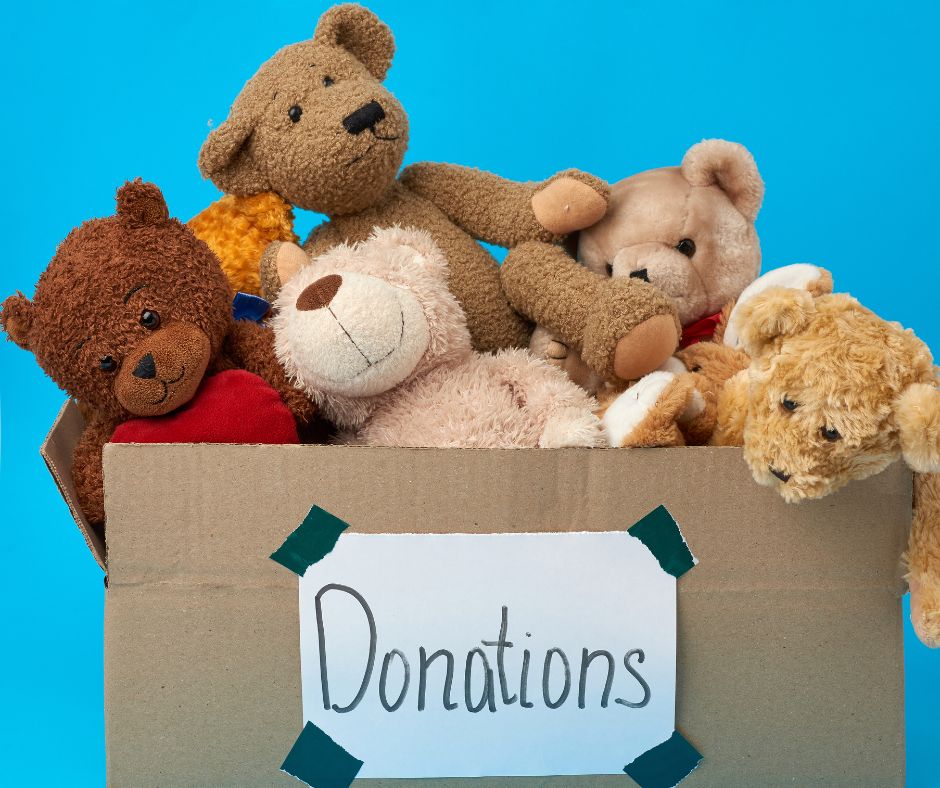 Cardboard box of stuffed animals labeled with "Donation"